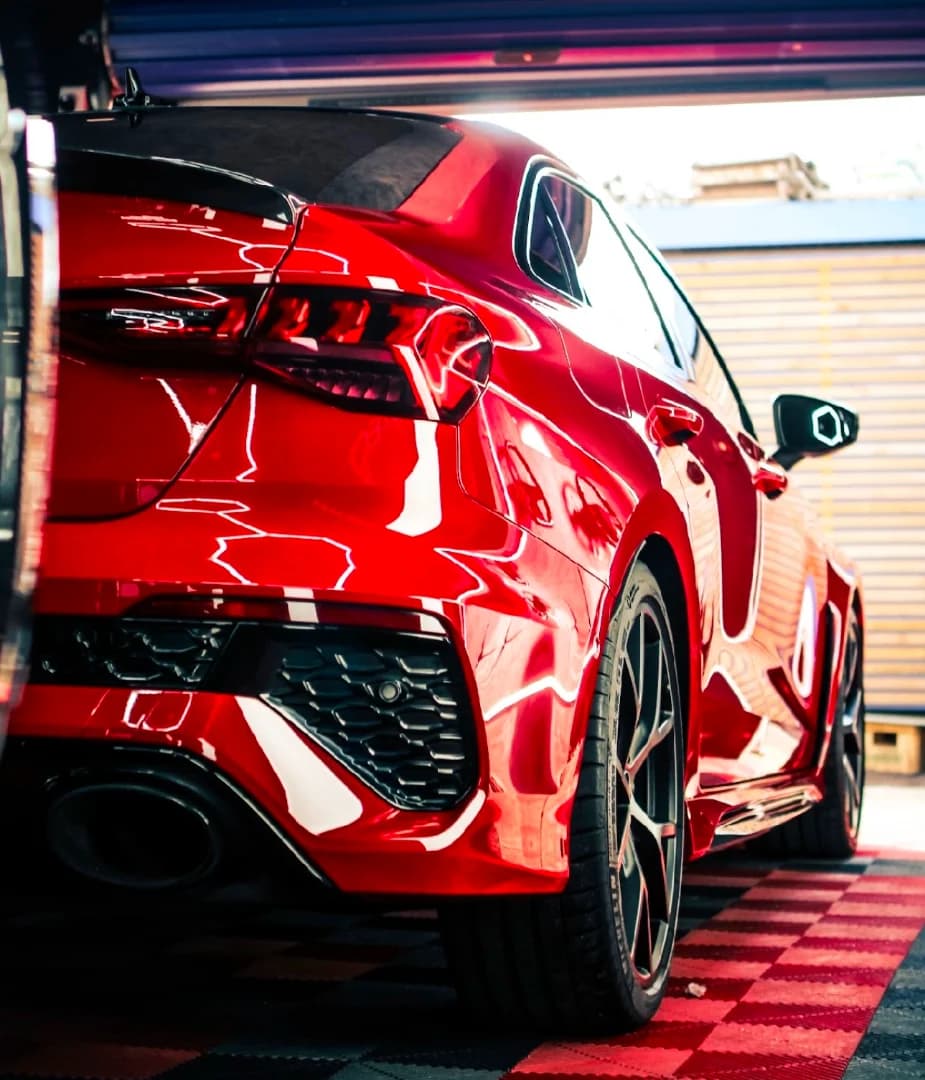 Multi-stage paint correction creating showroom shine on luxury vehicle